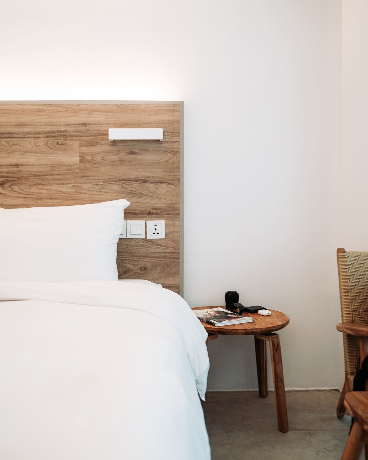 Hotel guest room with white bed linen and a wooden headboard