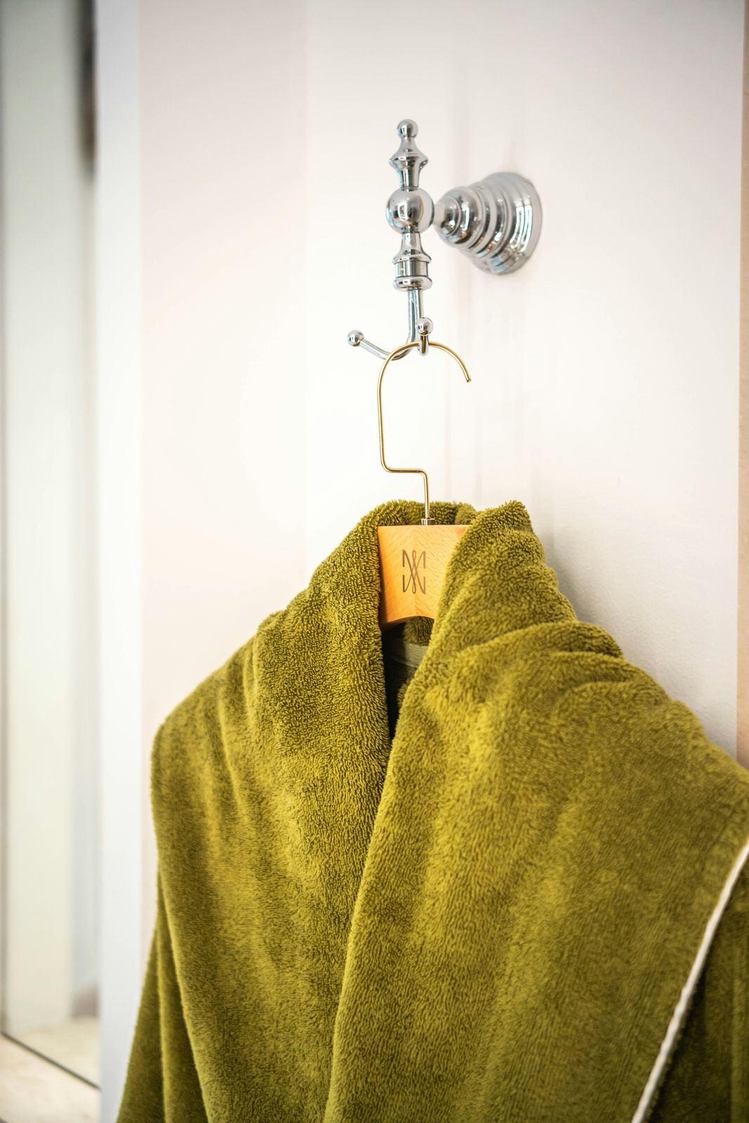 Terry bathrobe hanging in a hotel bathroom