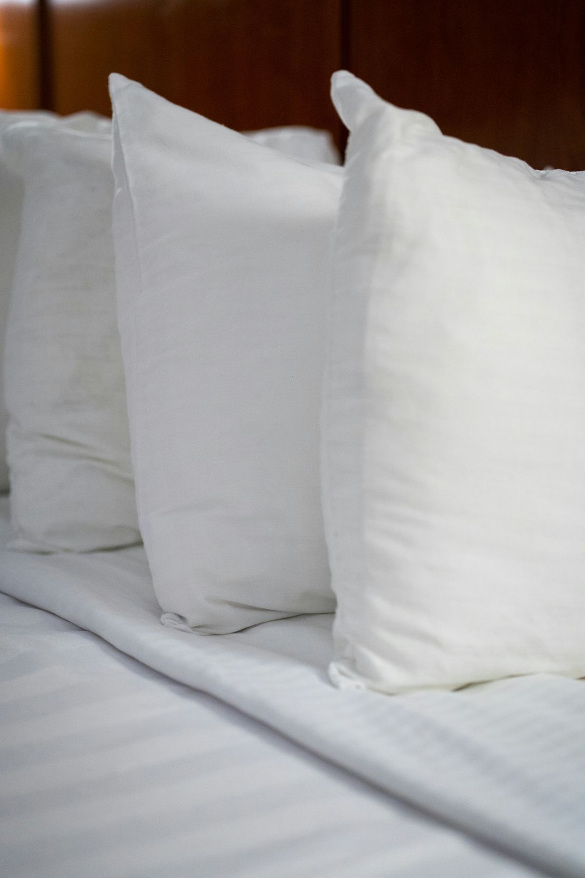 White pillows and linen on a made hotel bed